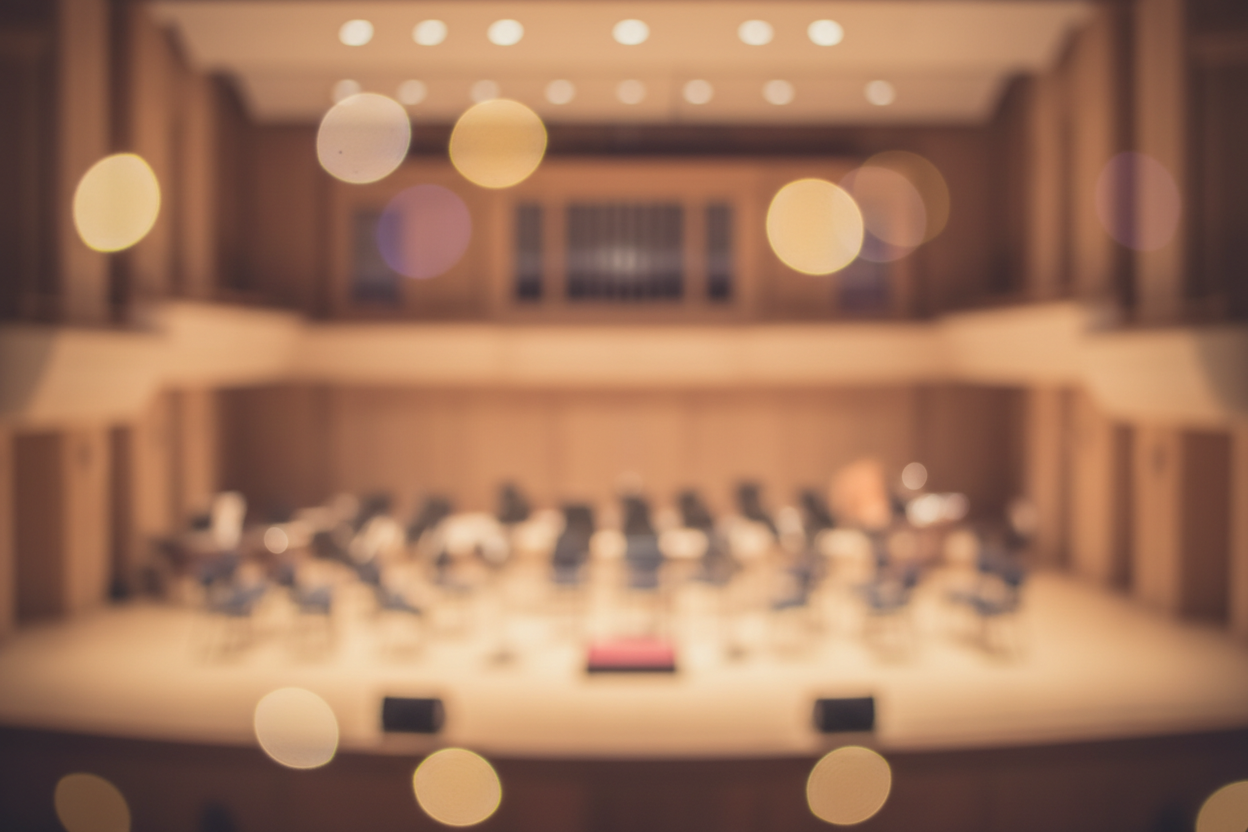 Soft blurred symphony stage with warm lighting